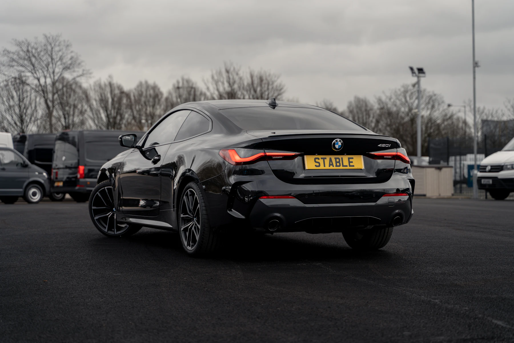 Rear three-quarter view showing the coupé roofline and taillights