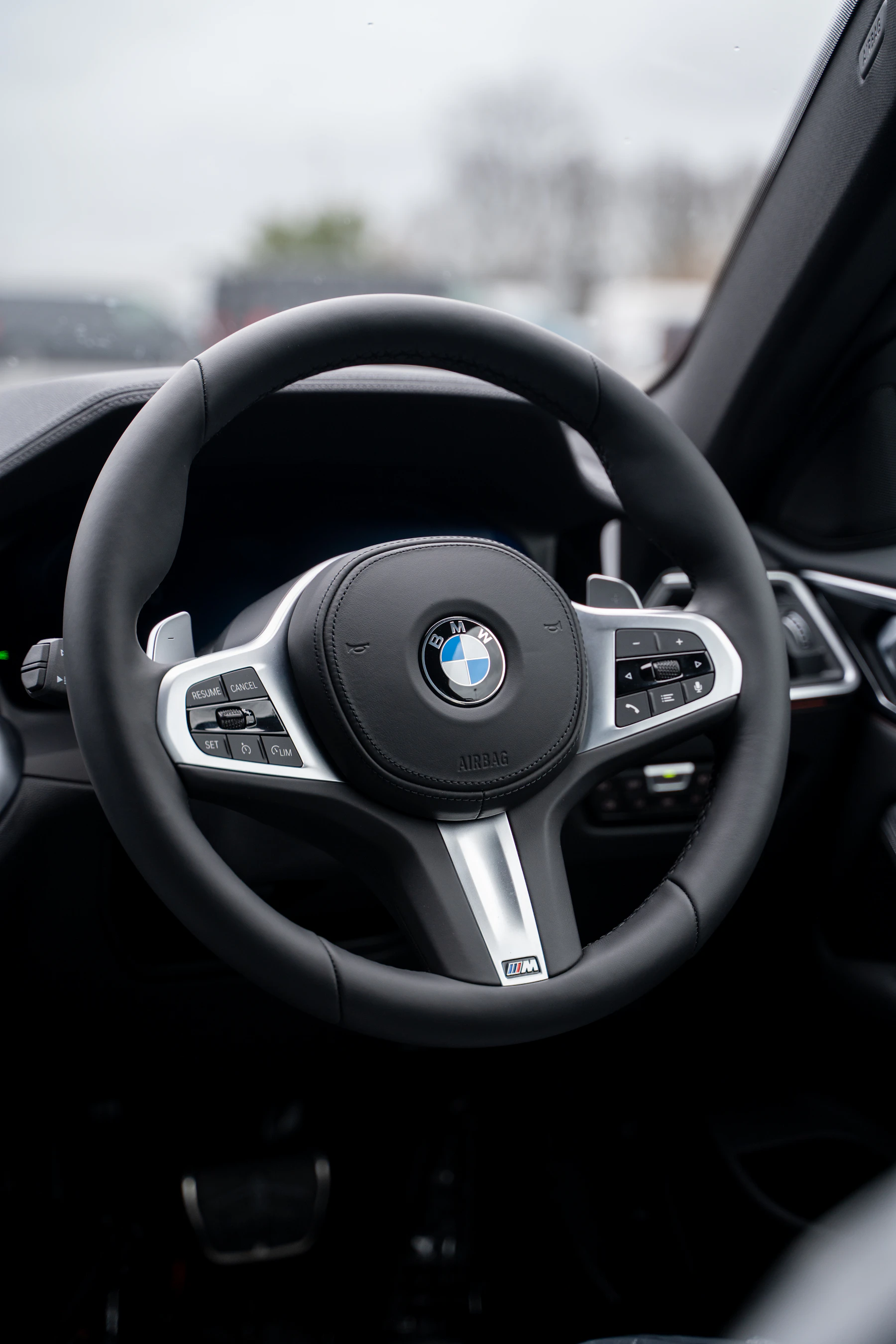 M Sport steering wheel with M badge on the lower spoke